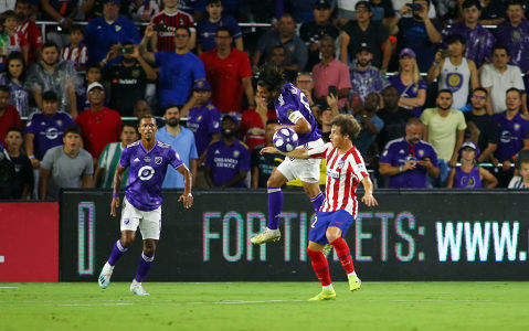 Carlos Vela heads the ball away from an Athletico Madrid player — soccer — MLS, soccer, allstar