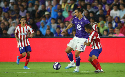 Zlatan Ibrahimovic holds off the Athletico Madrid defender — soccer — MLS, soccer, allstar