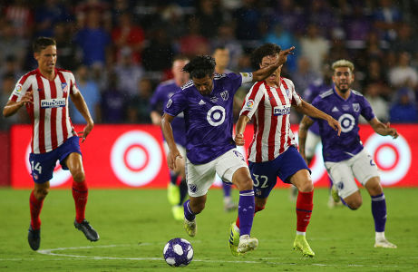 Carlos Vela runs in front of Rodrigo Riquelme — soccer — MLS, soccer, allstar